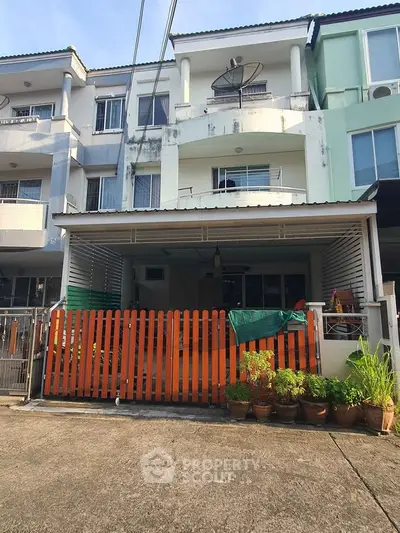 Charming townhouse with gated entrance and balcony, ideal for family living in a serene neighborhood.