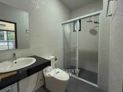 Modern bathroom with sleek shower enclosure and stylish fixtures