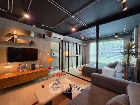 Modern living room with open layout, stylish decor, and natural light from large windows.