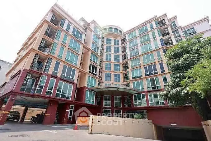 Modern multi-story residential building with large windows and a welcoming entrance.