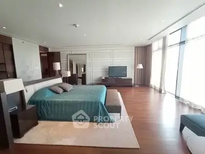 Luxurious spacious bedroom with elegant decor and large windows offering ample natural light.