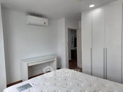 Modern bedroom with air conditioning and sleek white furniture
