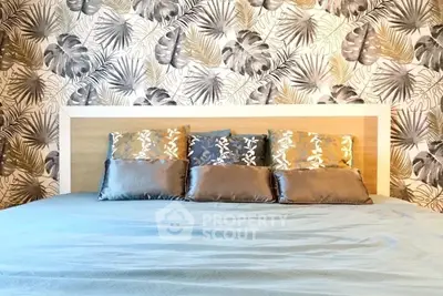 Stylish bedroom with elegant wallpaper and plush pillows, perfect for a cozy retreat.