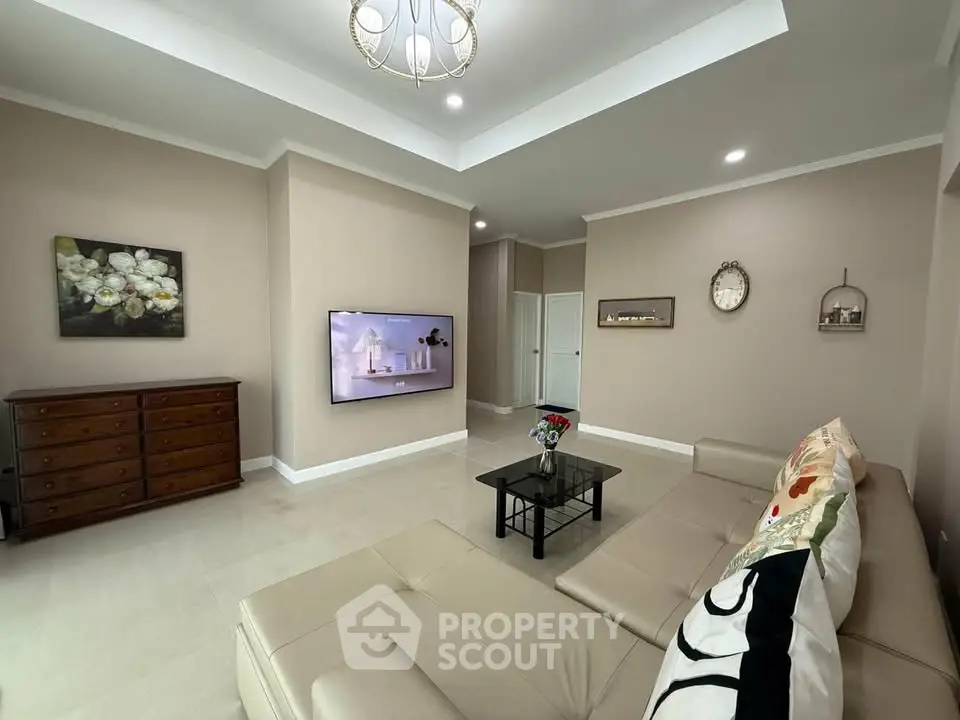 Spacious modern living room with elegant decor and wall-mounted TV