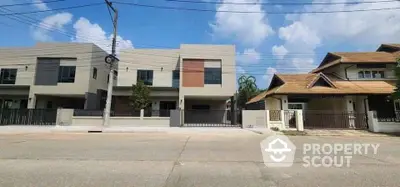 Modern residential houses with contemporary design and spacious driveways in a suburban neighborhood.