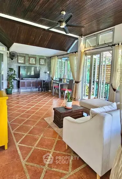 Spacious living room with modern decor and large windows offering natural light.