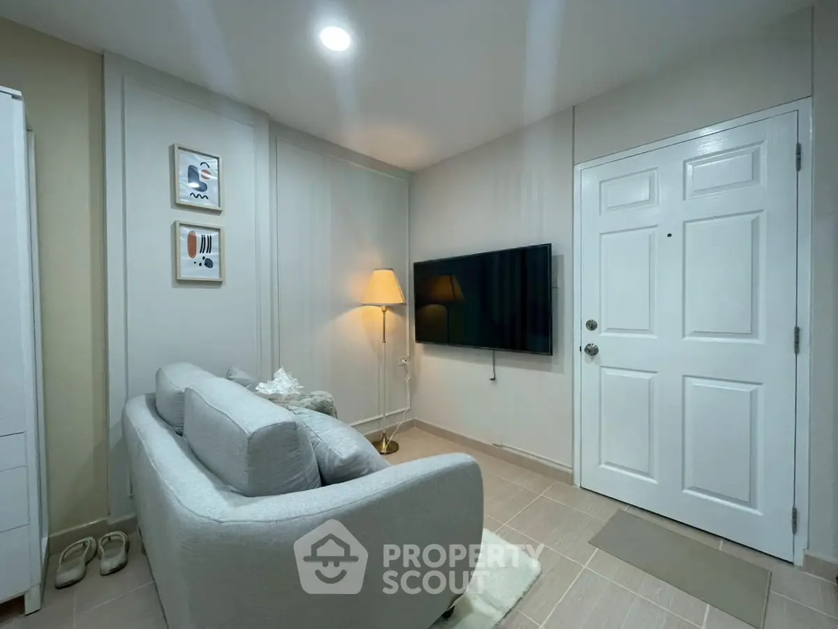 Cozy living room with modern decor and wall-mounted TV