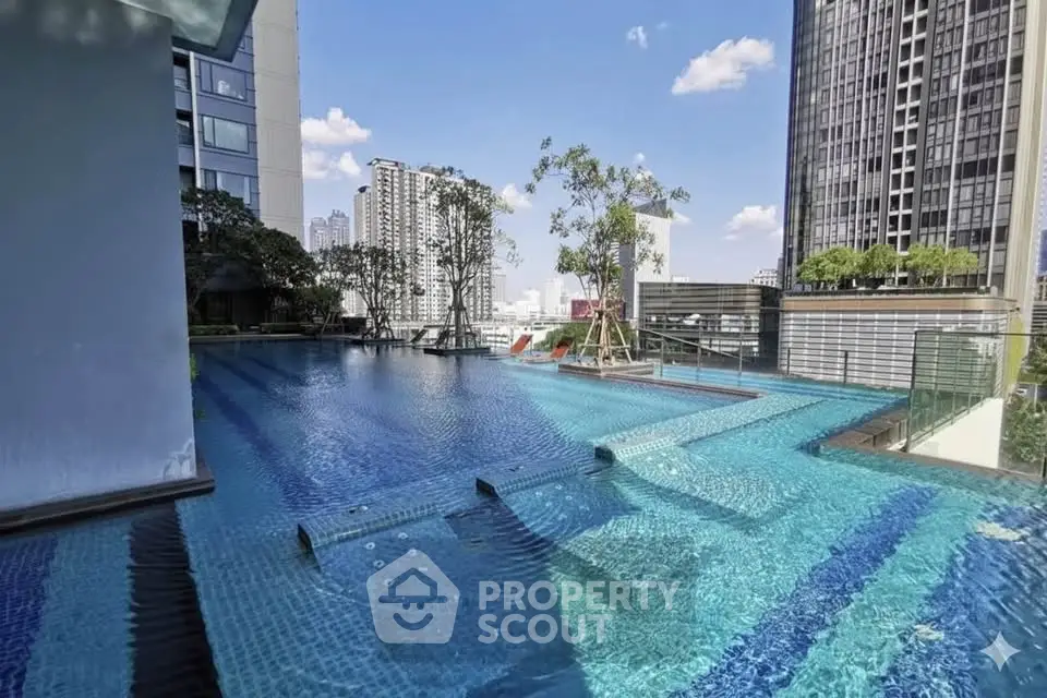 Luxurious rooftop pool with stunning cityscape views in modern high-rise building.