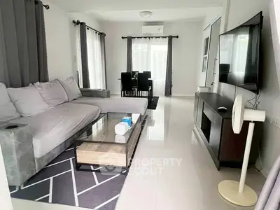 Modern living room with sleek furniture and large windows for natural light