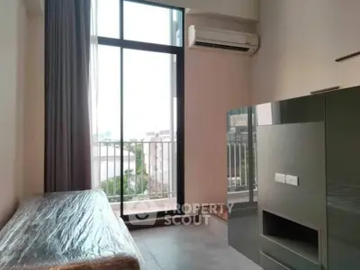 Modern apartment interior with large window and air conditioning unit
