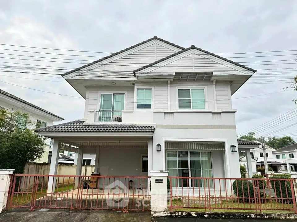 Charming two-story house with modern design and spacious driveway in a serene neighborhood.