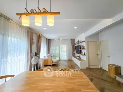 Spacious modern living room with elegant wooden flooring and stylish lighting
