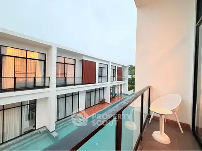 Modern balcony view overlooking luxurious pool and stylish architecture