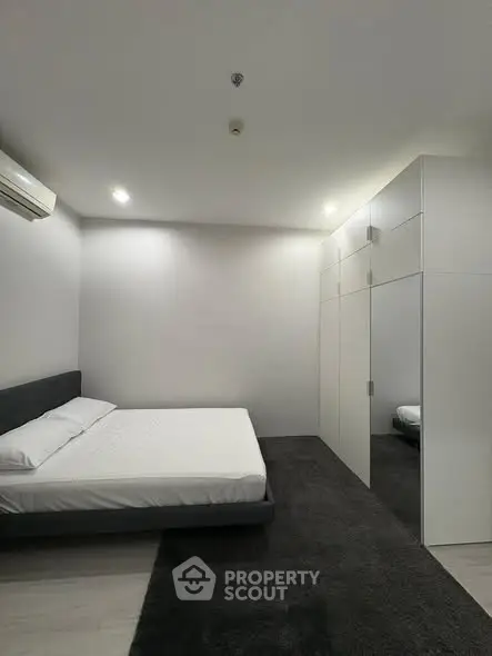 Modern minimalist bedroom with sleek design and ample storage space