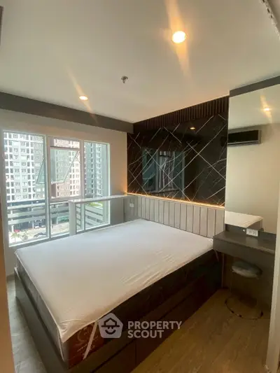 Modern bedroom with large window and stylish decor in urban apartment