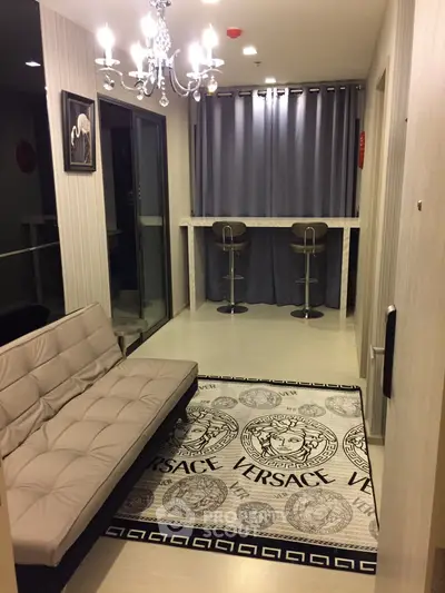Stylish modern living room with elegant chandelier and Versace-themed decor