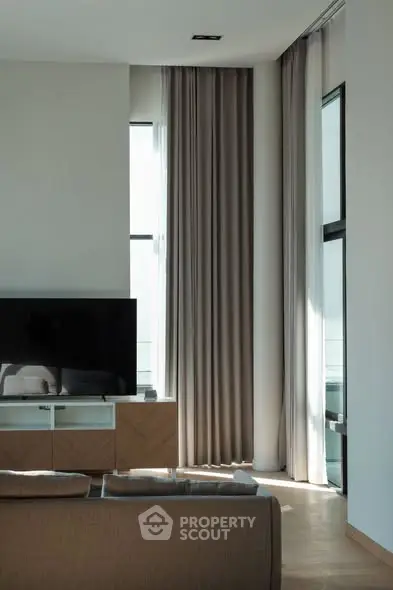 Modern living room with large windows and stylish decor