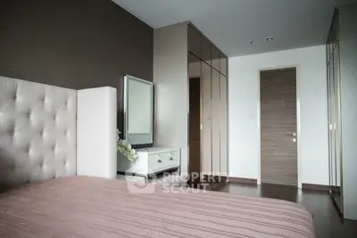 Luxurious bedroom with elegant decor and mirrored wardrobe doors