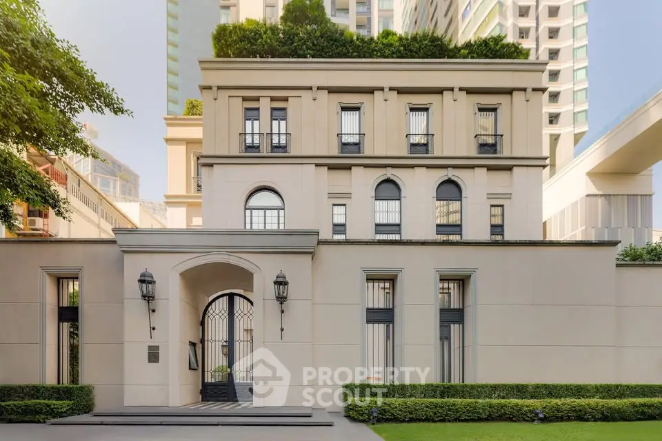 Elegant luxury building exterior with lush greenery and modern architecture.