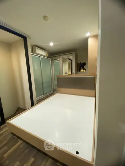 Modern bedroom with sleek design and ample storage in a stylish apartment.