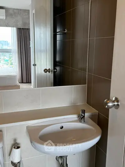 Modern bathroom with sleek sink and partial bedroom view