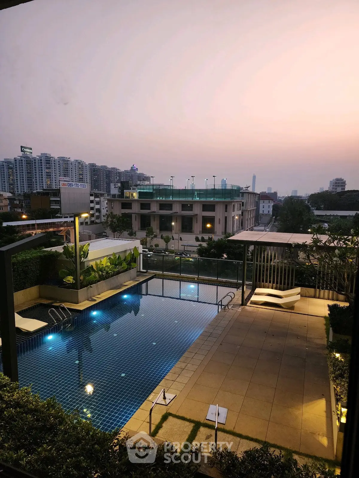 Luxurious rooftop pool with stunning cityscape view at sunset