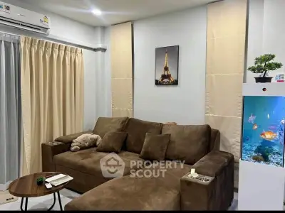 Cozy living room with plush brown sofa and decorative fish tank