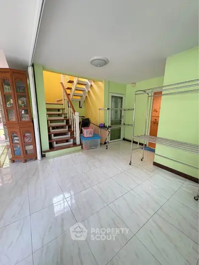 Spacious interior with staircase and tiled flooring, ideal for modern living.