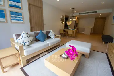 Modern living room with stylish decor and open layout, featuring a cozy sofa and elegant dining area.