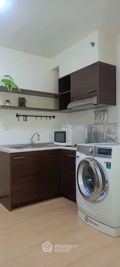 Modern kitchen with washing machine and sleek cabinetry