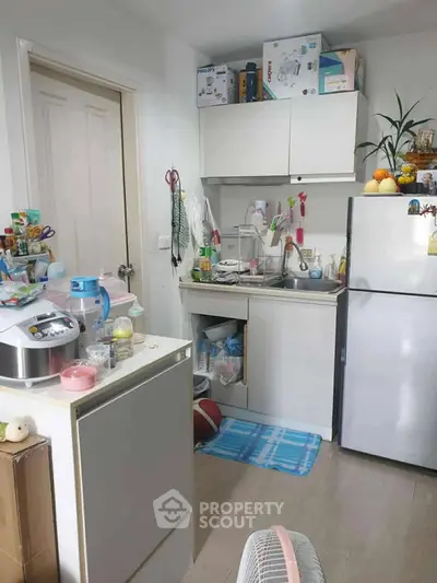 Cozy kitchen with modern appliances and compact design, perfect for efficient cooking.