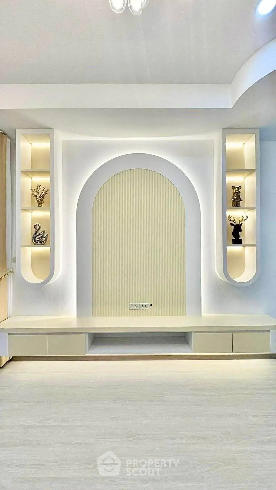 Modern living room with elegant built-in shelving and soft lighting