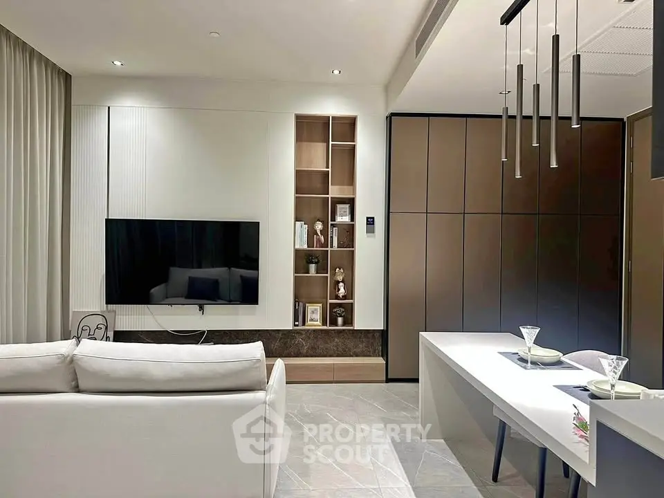 Modern living room with sleek design, wall-mounted TV, and elegant dining area.
