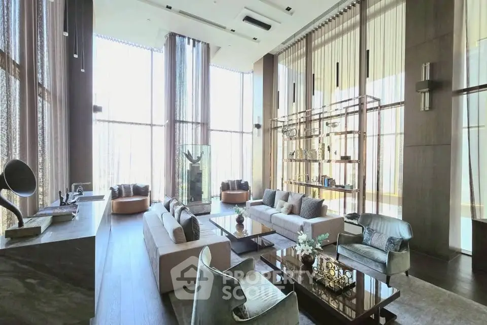 Luxurious high-ceiling living room with elegant decor and floor-to-ceiling windows