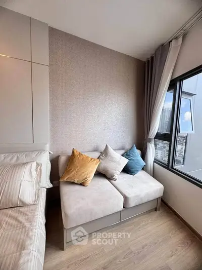 Cozy bedroom with modern decor and city view from large window