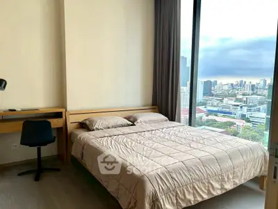 Modern bedroom with city view and cozy furnishings