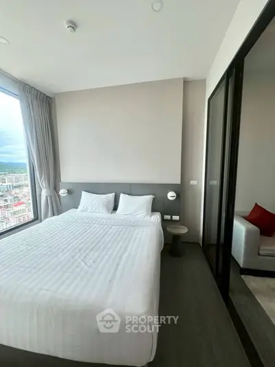 Modern bedroom with city view and elegant decor in high-rise apartment