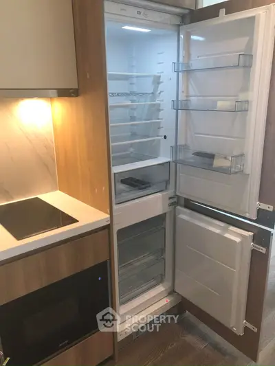 Modern kitchen with built-in fridge and sleek appliances