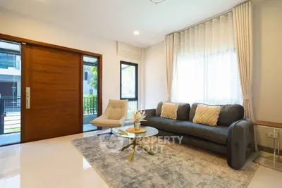 Modern living room with elegant decor, large windows, and stylish furniture in a contemporary home.