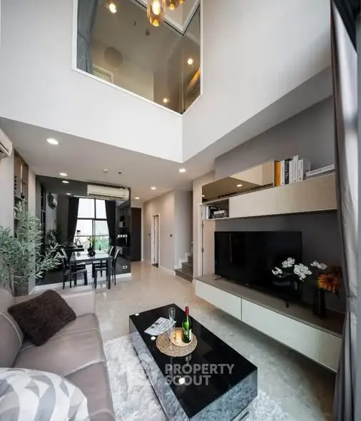Modern duplex living room with high ceiling and stylish decor