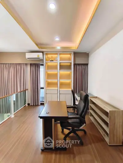 Modern study room with elegant wooden flooring and built-in shelves, perfect for productivity.