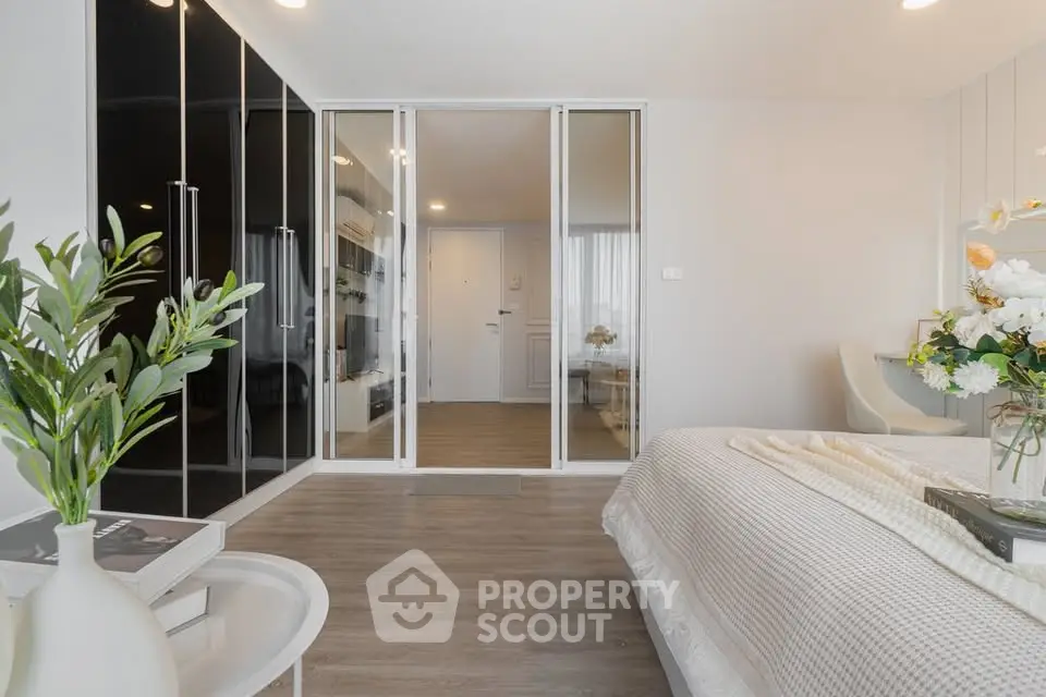 Modern bedroom with elegant decor and glass wardrobe doors