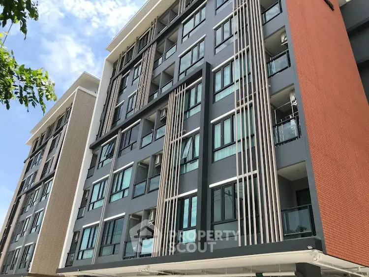 Modern apartment building exterior with sleek design and large windows