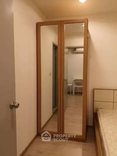 Cozy bedroom with mirrored wardrobe and minimalist decor