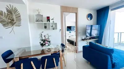 Modern living room with stylish decor and open view balcony in a contemporary apartment.