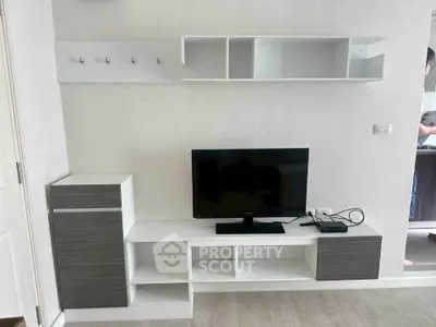 Modern living room with sleek TV stand and open shelving, perfect for stylish urban living.