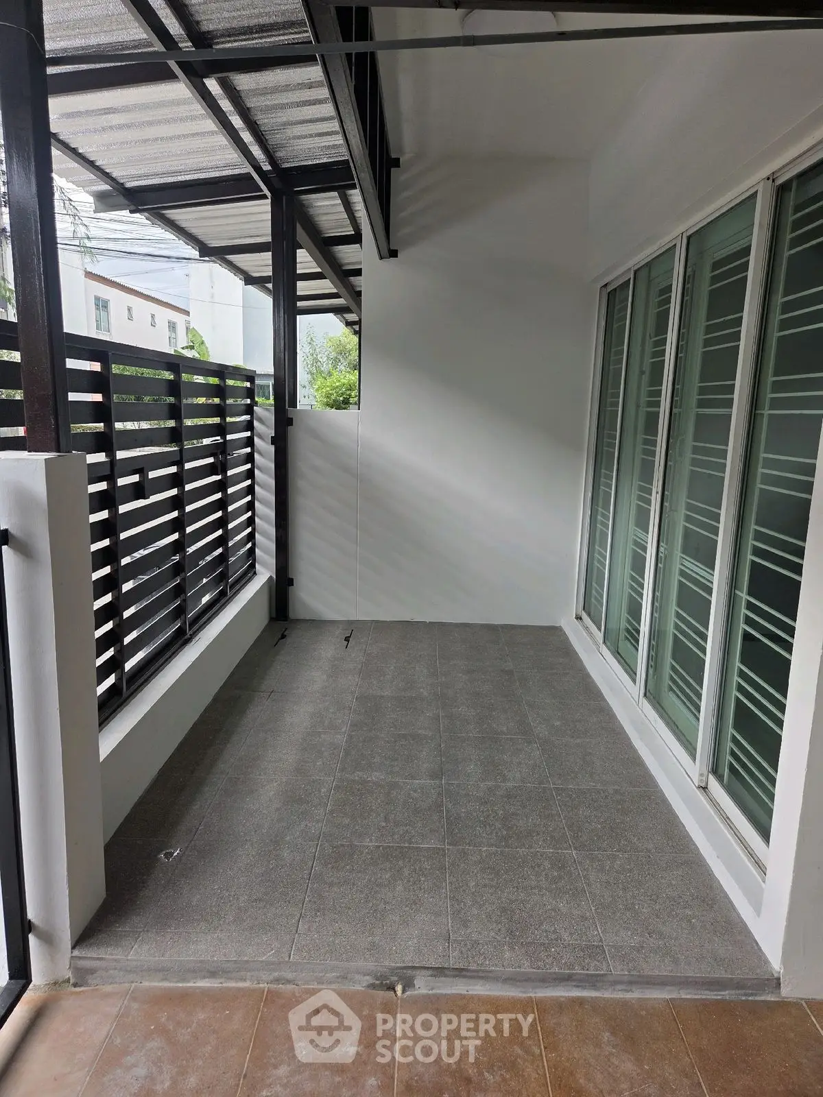 Spacious balcony with modern design and tiled flooring, perfect for relaxation.