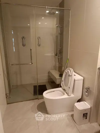 Modern bathroom with glass shower and sleek toilet design