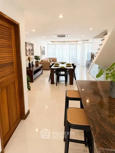 Spacious open-plan living and dining area with modern decor and natural light.