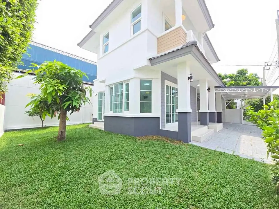 Charming two-story house with lush green lawn and modern exterior design.